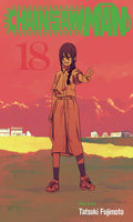 Comic book cover of 'Chainsaw Man' with a character in an open field and red sky.