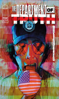 Comic book cover titled 'The Department of Truth' with a person wearing a cap and sunglasses, holding an American flag.