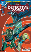 Comic book cover of Detective Comics featuring Batman, Robin, and Batgirl on an orange background.