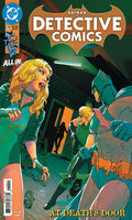 Comic book cover of Detective Comics featuring Batman and a woman in a green outfit.