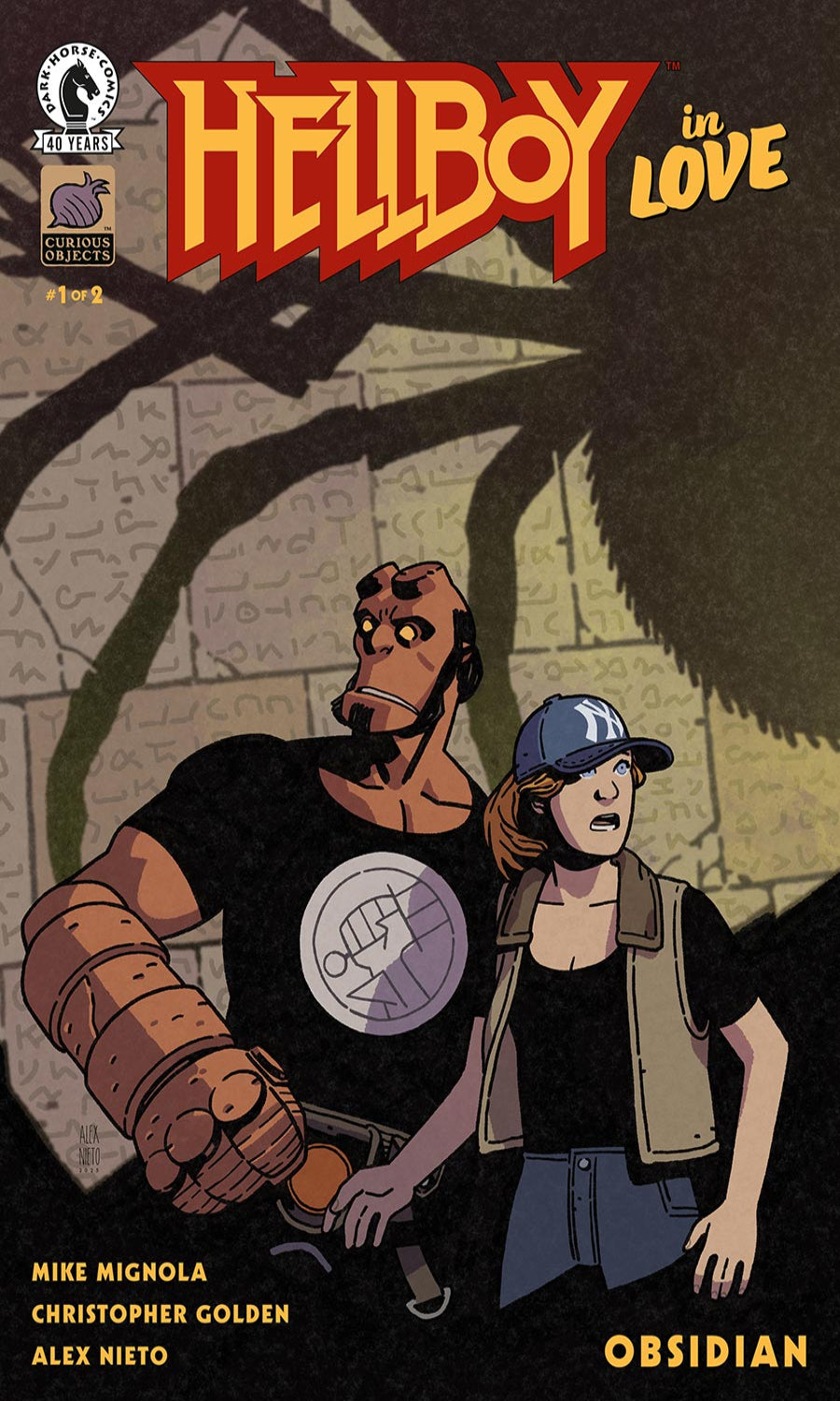 Comic book cover of 'Hellboy in Love' featuring Hellboy and a woman in a dark setting.