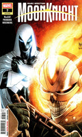 Marvel's MoonKnight comic book cover, issue 7, featuring Marc Spector in a white hooded suit with glowing blue eyes beside a flaming metallic skull-like helmet, with the title 'MoonKnight' across the top.