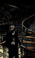 Person in a dark suit and mask standing in a library with books on shelves.