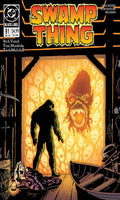 Comic book cover of 'Swamp Thing' with a silhouette of a creature and fiery background.
