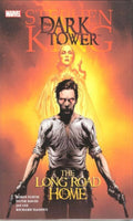 Comic book cover of 'The Dark Tower: The Long Road Home' featuring a character with a gun and a glowing figure.