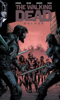 Comic book cover of 'The Walking Dead' with characters holding weapons.